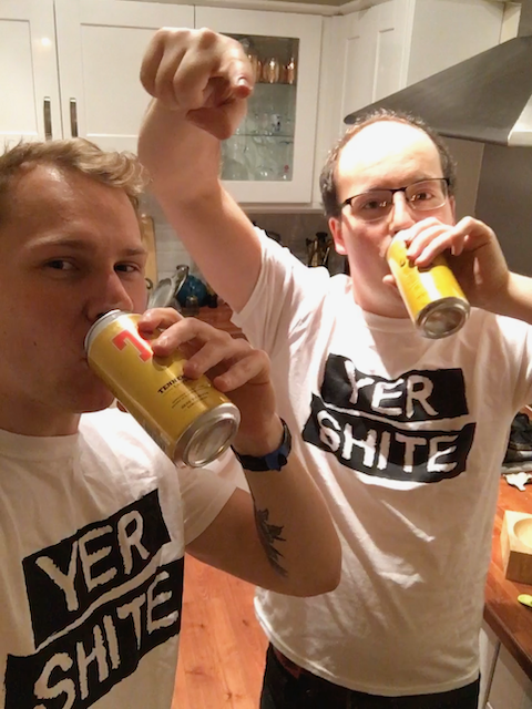 Site logo. A picture of Will & Nathan holding tins of Tennent's, wearing t-shirts saying 'YER SHITE' on them in large letters.